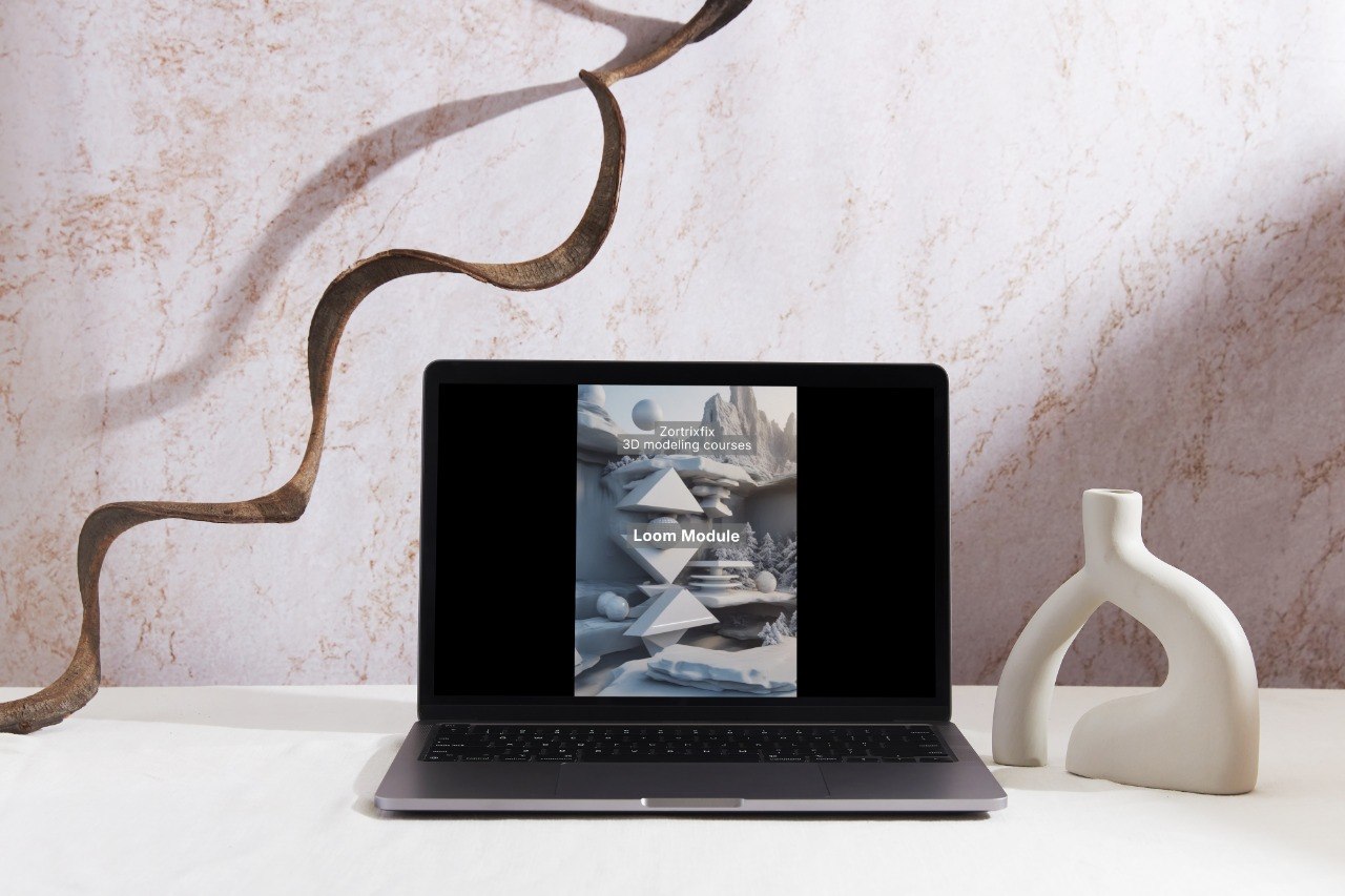 Laptop on a white surface with a decorative vase and abstract wall art in the background